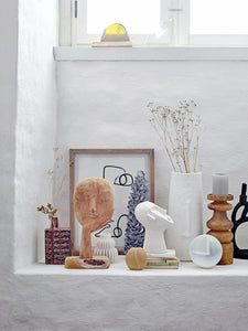 White Vase with Facial Features on Ledge