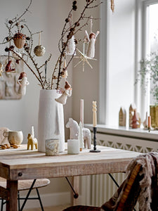 White Vase with Facial features on table