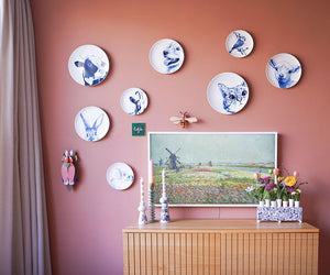 a collection of blue and white wall plates with animal motif