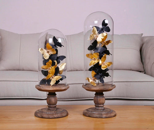 Glass dome with black and gold paper butterflies