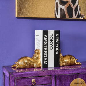 Gold Hippo Bookends on side table holding up books