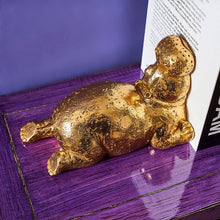 Load image into Gallery viewer, Hippopotamus Bookend in Gold on Purple tabletop