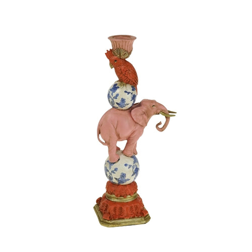 A coral parrot sits on top of a pink elephant as a whimsical candle holder